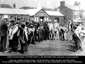 Black-and-white photograph of a golf demonstration at Southport Golf Club, showing a central figure putting while a large group of adults and children gather in a semicircle watching. Text at the bottom describes Harold Hilton holding a putting clinic and lists golfing achievements.